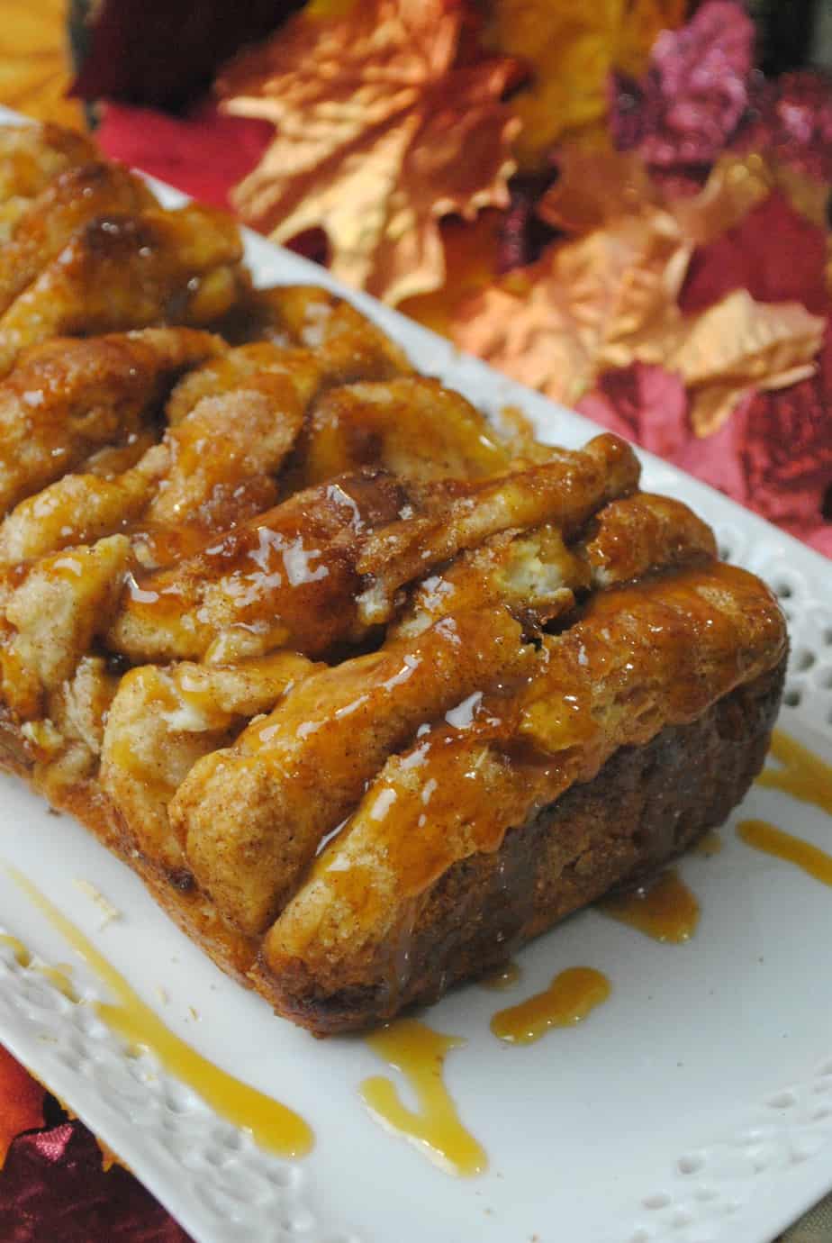 Pull Apart Pumpkin Bread on a white tray with leaves in the background