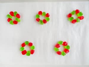 halved red and green jolly rancher candies arranged in a circle on white paper
