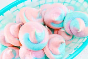 pink and blue meringues in a blue basket 