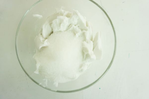 sugar and coconut cream in a glass bowl on a white table