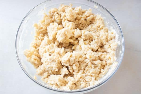 crumble mixture in a glass bowl on a white counter