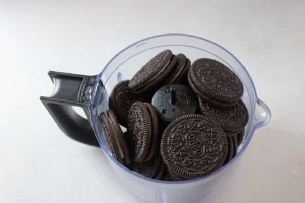 oreo cookies in a food processor on a white counter