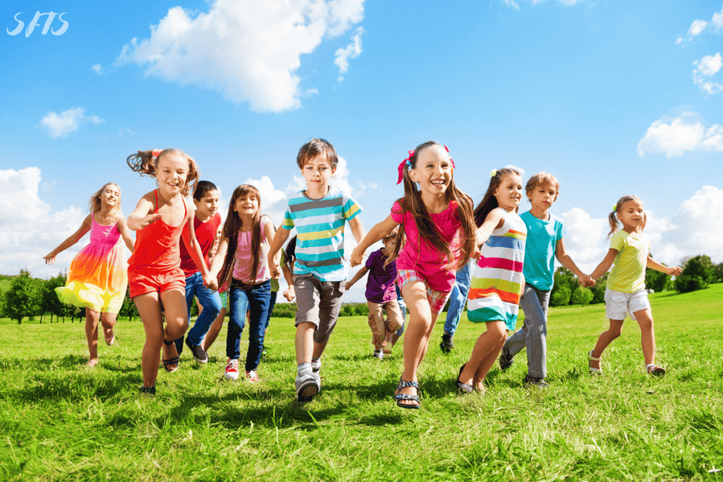 An image of kids running forward in a field.
