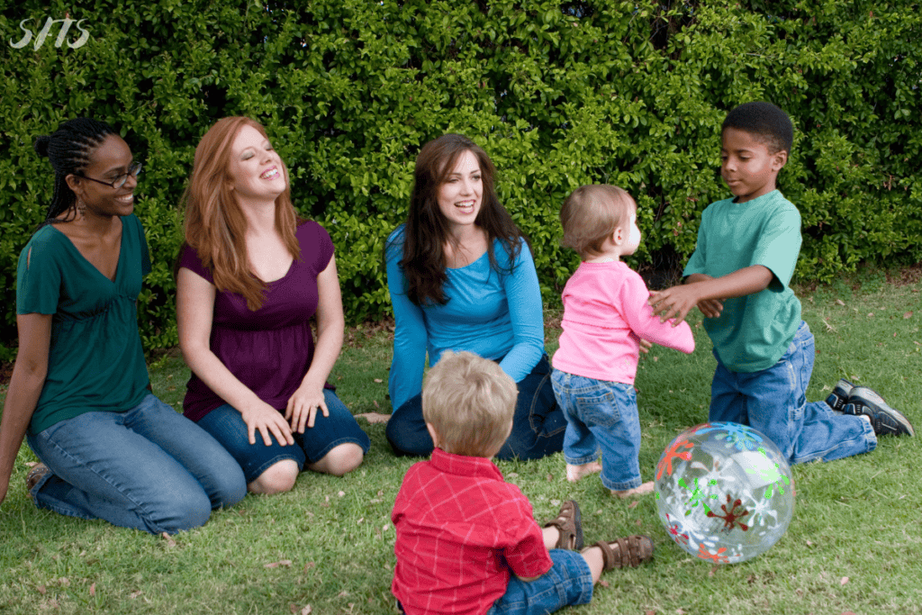 An image of mothers with their kids playing.