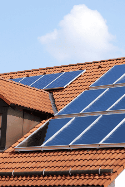 An image of solar panels on a roof of a house.