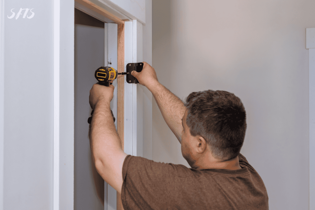 An image of a man installing a hidden door.